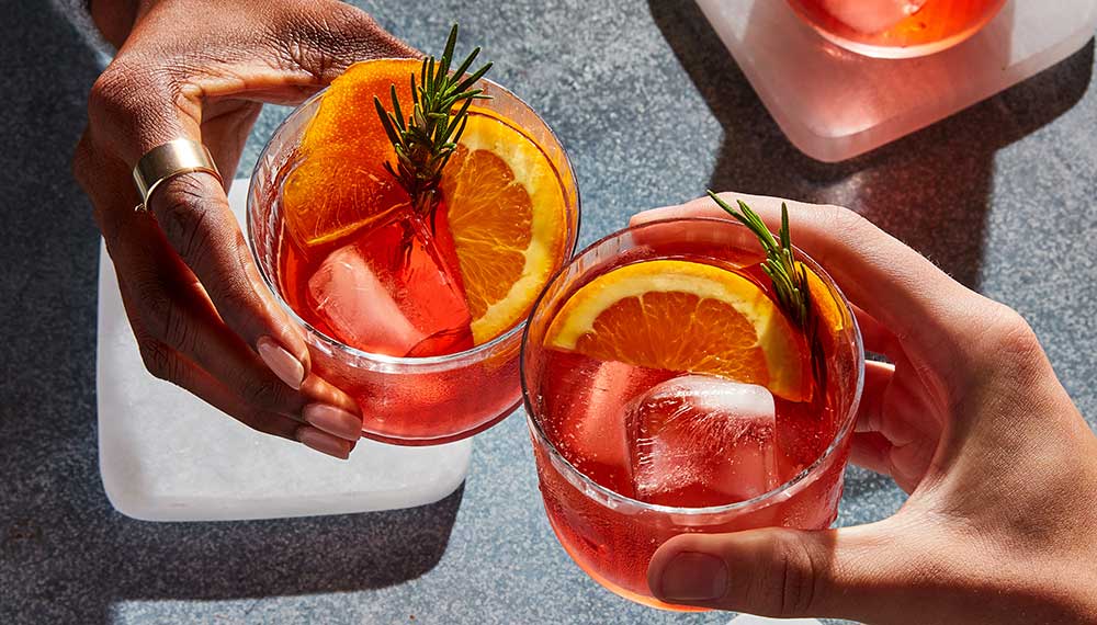 Colorful cocktails cheers between friends